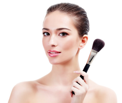 Pretty woman with makeup brush