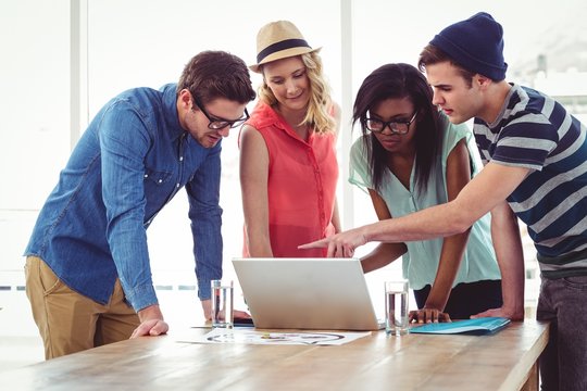 Creative Business Team Working Hard Together On Laptop