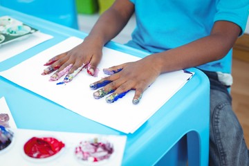 Happy kid enjoying arts and crafts painting