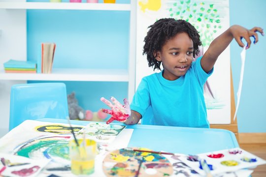 Happy Kid Enjoying Arts And Crafts Painting