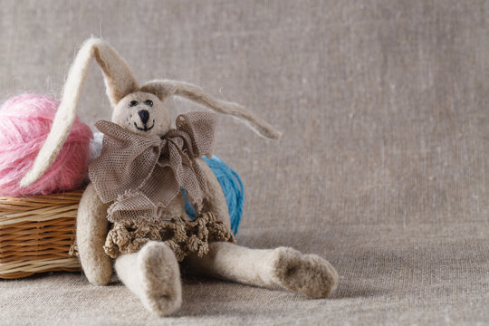 Homemade tilda doll and colored clew in backed