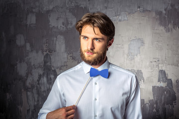Young man holding blue paper bow-tie