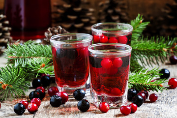 Winter drink with cranberry, cowberry and black chokeberry on th