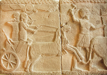 Hunting scene on ancient Assyrian bas-relief from 8th century BC