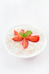 Oatmeal porridge with strawberry slices