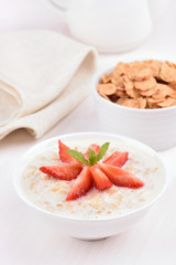 Oatmeal porridge with strawberry slices