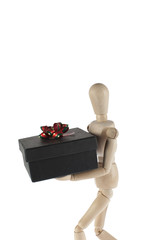 wooden male model carries gift box