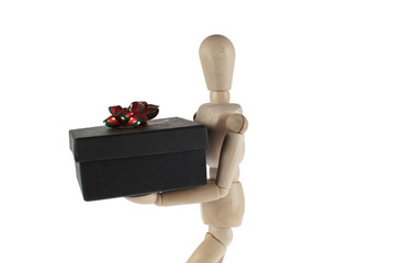 wooden male model carries gift box