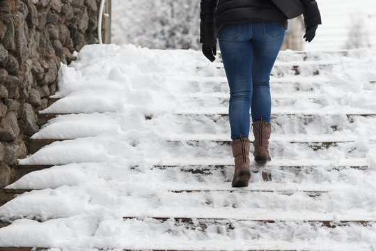 man climbs the stairs in the snow