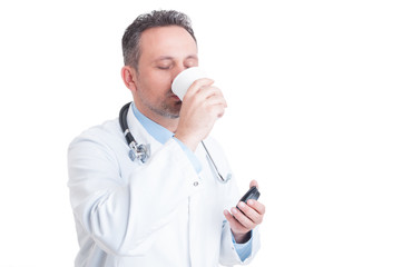 Medic or doctor drinking coffee from disposable cup