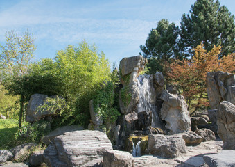 Fototapeta na wymiar Waterfall in chinese authentic Garden of the Reclaimed Moon