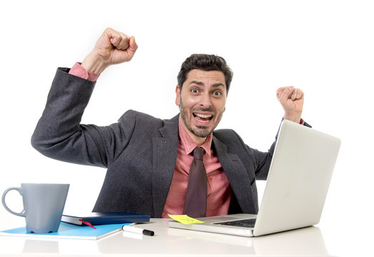 attractive businessman working happy at office computer excited and euphoric