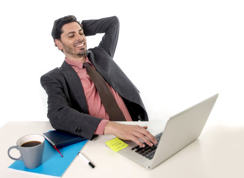 businessman leaning on chair working at office computer laptop looking happy satisfied and relaxed