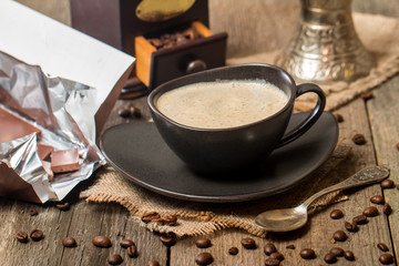 Cup of coffee with coffee beans and chocolate