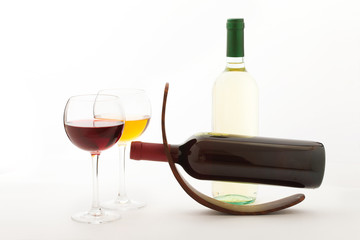 Glasses and bottles of wine unusually on white background.