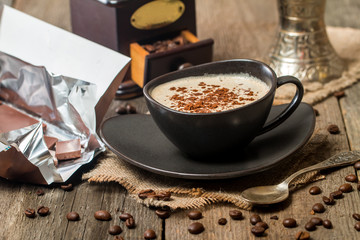 Cup of coffee with coffee beans and chocolate