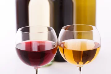 Fotobehang Glasses and bottles of wine unusually on white background. © missty