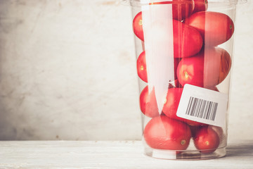 Fototapeta premium Tomatoes in the plastic container close-up