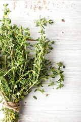 Bunch of thyme on the white board vertical - obrazy, fototapety, plakaty