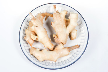 fresh ginger in white plate on  white background