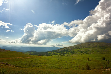 Fototapeta na wymiar Beautiful mountain landscape with white clouds in the blue sky