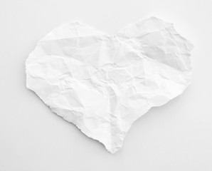 crumpled paper on a white background. Crumpled paper in heart shape