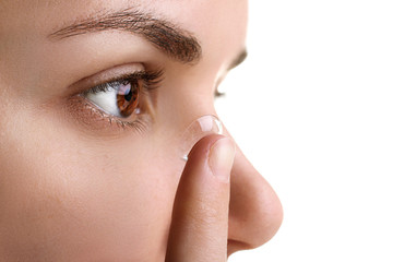 contact lens on your finger comes to the eye on a white isolated background