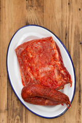 raw marinated pork with smoked sausage