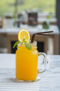 Orange juice with ice in a glass
