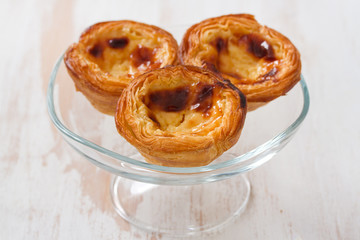 traditional portuguese cookies pasteis de nata on white wooden background