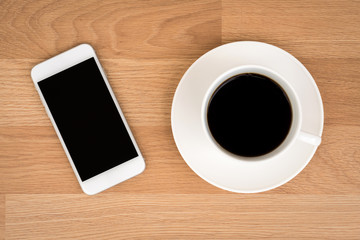Fototapeta na wymiar Coffee with smart phone on wood table