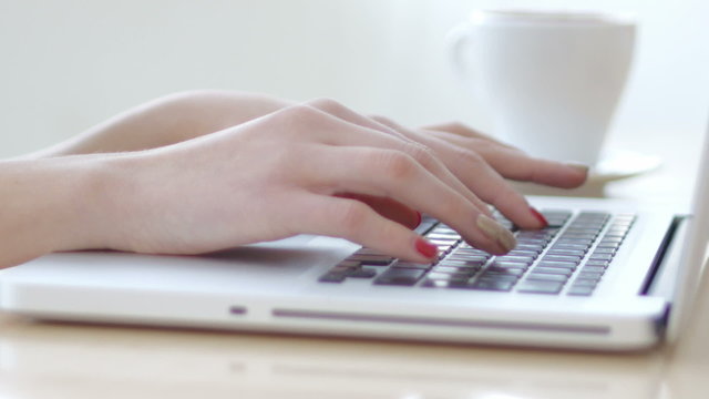 Female hands wrighting on laptop