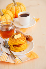 Pumpkin pancakes on white plate with butter and honey © julijadmi