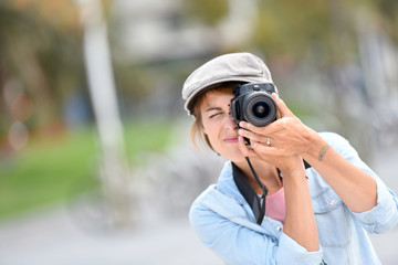 Young woman photographer on a shooting day in town