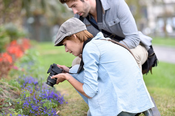 Photographers in park shooting vegetation