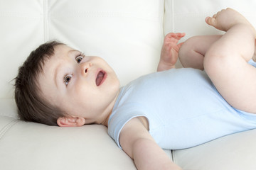 baby boy relaxing in sofa at home