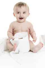 Toddler ripping up toilet paper in bathroom studio