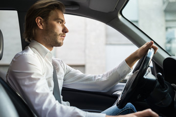 Man driving his car in the city