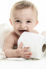 Toddler ripping up toilet paper in bathroom studio