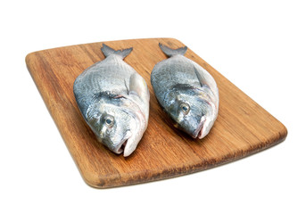 dorado fish on a cutting board on a white background