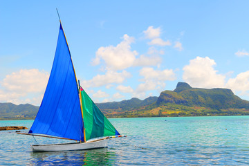 Fototapeta na wymiar Sailboat in Mahebourg bay with Morne Brabant on background. Mauritius island.