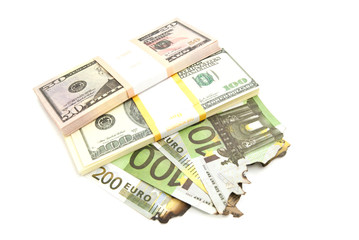 dollars and burned euros on white