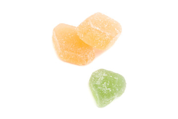 three sweet fruit candies on white