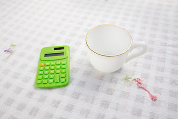 A cup of coffee with calculater