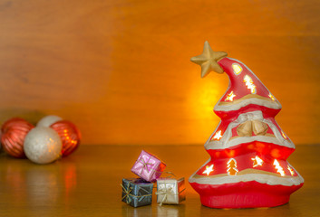 A softly glowing Christmas tree on a wooden background.