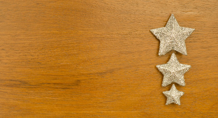 Silver  Christmas star  on wood background .