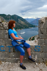 Fototapeta premium Young woman looks at Bay of Kotor