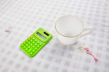 A cup of coffee with calculater