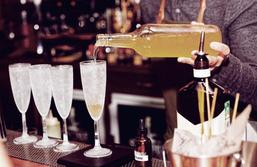 Bartender is pouring liquor in glass