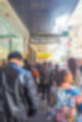 Abstract blur Crowd of anonymous people walking on busy  street